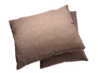 Fototapeta na wymiar Two brown pillows on white background, top views