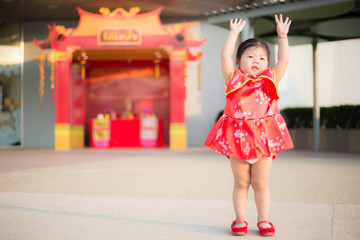 Girl in red Chinese dress.