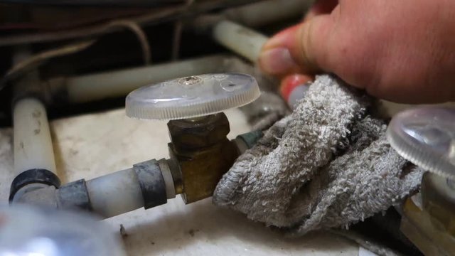 Fixing a leak of water in the plumbing lines of an RV.