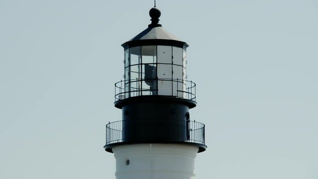 Close-up of light rotating at Portland Head Lighthouse on the coast of Maine near Cape Elizabeth on a nice summer day.
