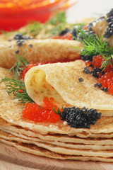 Russian pancakes with red and black caviar