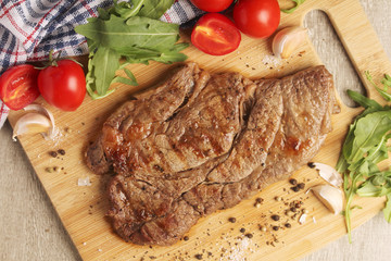 A beef steak well done with vegetables