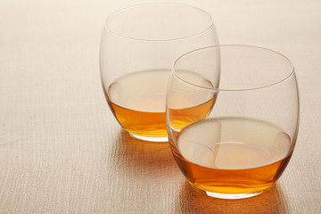 Two glasses with whiskey without ice cubes