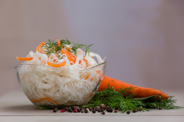 pickled cabbage with carrots on a light background close-up