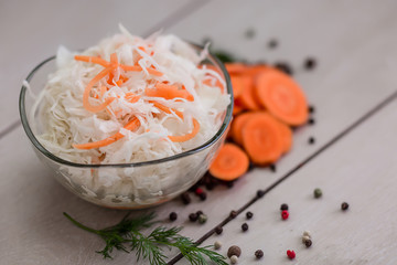 pickled cabbage with carrots on a light background close-up