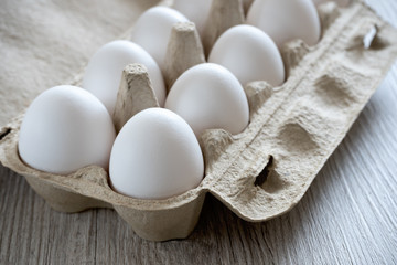 Chicken eggs on wooden table.