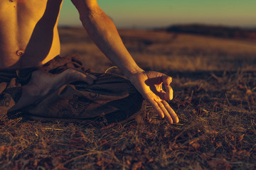 Yogi man meditating at sunset on the hills. Lifestyle relaxation emotional concept spirituality...
