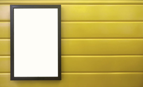 beautiful notification borad hanging on the colorful metal wall, black frame placing on bright yellow wall, square black pan on colorful yellow background