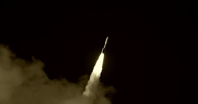 Space Rocket or ICBM missile emerging from behind clouds and flying through black sky with bright flames and a nice trail of white exhaust smoke. 4K at  120 fps slow motion.