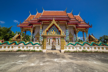 Fototapeta premium Buddhist temple Wat Kaew Manee Si Mahathat at sunny day in Phang Nga, Thailand