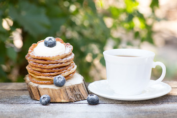 A stack of delicious pancakes with honey and blueberries on a wood background. with copy space