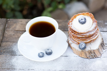 A stack of delicious pancakes with honey and blueberries on a wood background. with copy space