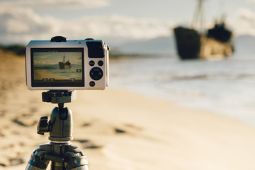 Camera on tripod and shipwreck