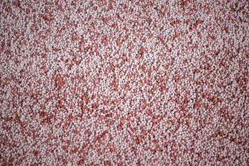 Shot of mixed chemical, artificial nitrogen plant fertilizer granules in factory. Big heaps of...