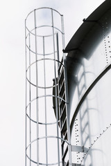 Industrial metal ladder with round railing