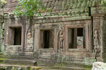 Fototapeta na wymiar Three temple windows decorated with stone statues