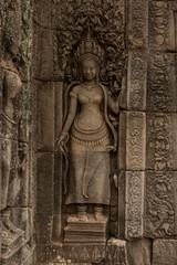 Statue of woman on ruined temple wall