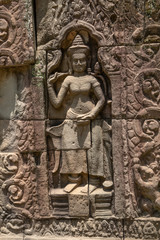 Statue of smiling man on temple wall