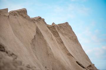 Large piles of construction sand and gravel used for asphalt production and building. Limestone quarry, mining rocks and stones 