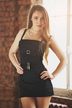 Brunette model girl posing for photo at the loft studio