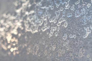 Frosty snowflake pattern on the window glass