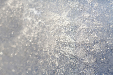 Frosty snowflake pattern on the window glass