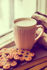 coffee and a sweater on the book by the window. bad mood.