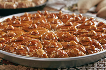 Turkish Baklava in a Round Metal Tray on Vintage Traditional Tablecloth