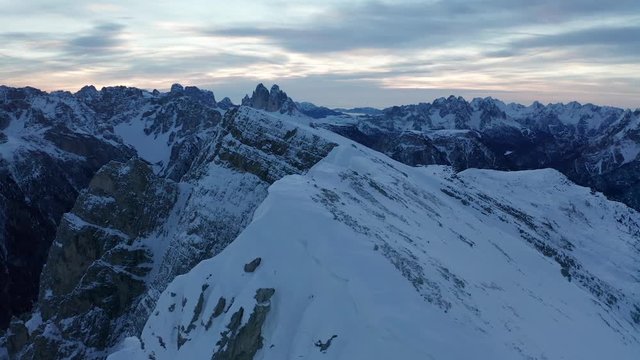 Aerial parallax around a ridge line near Durrenstein, a large mountain high up in the beautiful Dolomites of South Tyrol, Italy, looking out towards the stunning Tre Cime di Lavaredo
