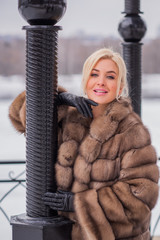 Nice elegant lady in fur coat at nature, autumn - winter season time, woman with attractive...