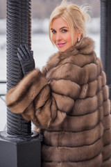 Nice elegant lady in fur coat at nature, autumn - winter season time, woman with attractive...
