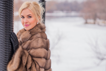 Nice elegant lady in fur coat at nature, autumn - winter season time, woman with attractive...