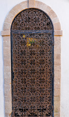 Old steel lattice pattern on the arabic window in Morocco (Marrakesh). Traditional oriental style and design in Muslim countries