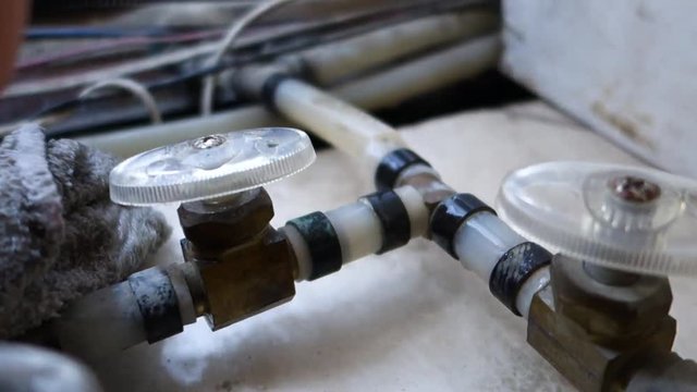 Draining the water of a leak in the motor of an RV.