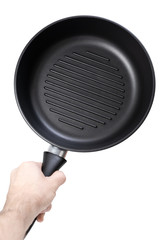 Man holding a cast iron frying pan of grill pan type isolated on white background