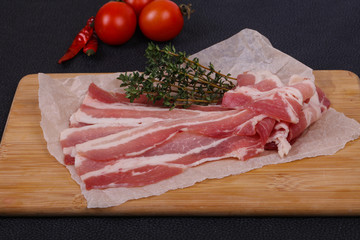 Raw bacon on the board