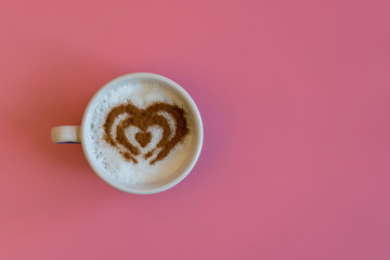 Heart Shape Coffee Cup Concept isolated on pink background. love cup , heart drawing on latte art coffee.
