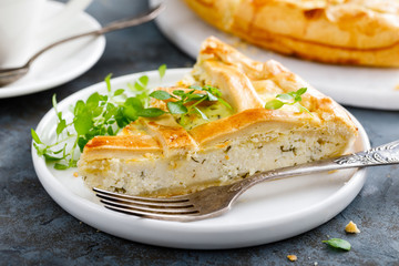Pie with salted soft cheese and greens
