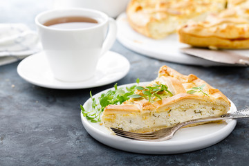 Pie with salted soft cheese and greens