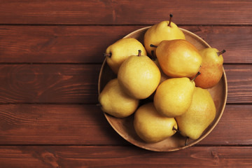 Ripe pears on wooden table. Space for text. Top view.
