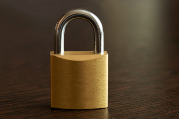 Padlock on wooden table. Close up