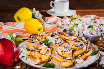 Apple pie and apple flowers, cup of coffee on wooden table. View from above.