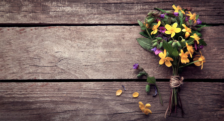 Wild flowers on old grunge wooden background