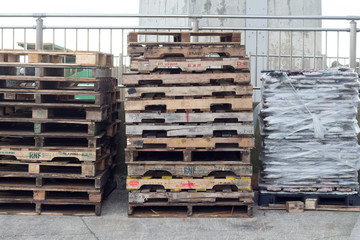 Piled wooden pallets at harbor