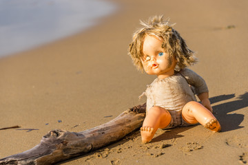 Cast Away Broken Doll Washed up on a Beach