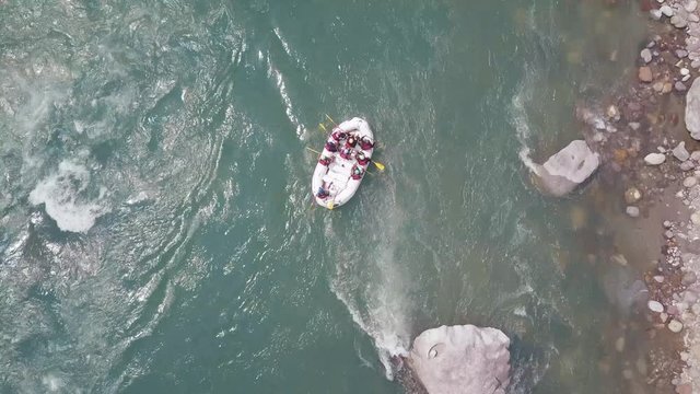 Colorful rafting boats floating on the Ganges River in Rishikesh, India at the foot of the Himalayas.