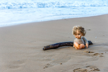 Cast Away Broken Doll Washed up on a Beach