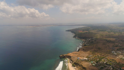 aerial view coastline with sandy tropical beach Balangan. seascape ocean surf and tropical beach large waves turquoise water crushing on shore, Bali,Indonesia. Travel concept.