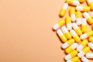 Multi-colored vitamins on a pink background. Place for text. Top view.