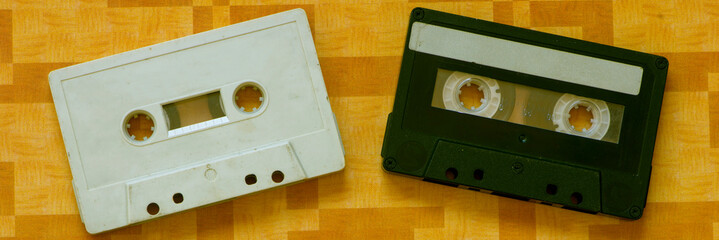Several music cassette tapes on an orange background
